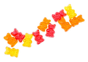 Colorful eat gummy bears isolated on a white background, top view.