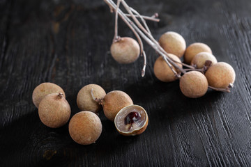 group longan fruits on a dark background.