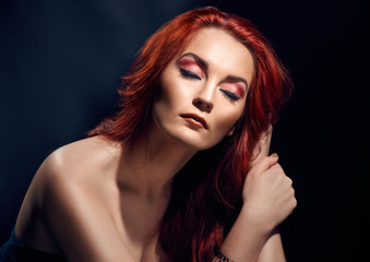 Fashionable portrait of beautiful redheaded model with naked shoulders
