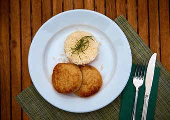 Baked Orange Chicken Meatballs with rice on a wood background