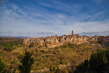Fototapeta na wymiar To outsiders, Pitigliano looks like a fairytale village, jetting from striking, wild ridges and surrounded by lush valleys carved by the Lente and Meleta rivers