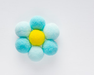 Delicate fluffy round pompons form a camomile