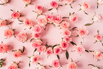 Flat lay frame border with blank copy space mockup made of pink rose flower buds on pink background. Top view floral concept.