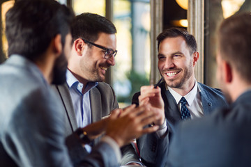 Smiling business people discussing together in office