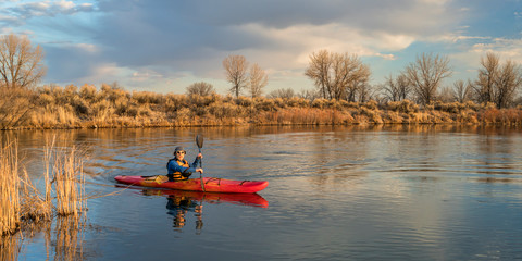 kayak paddling on lake in early spring