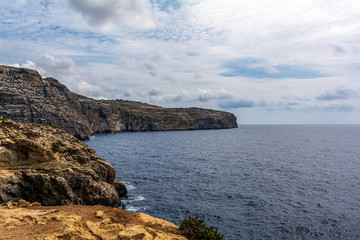 Fototapeta na wymiar Massive cliff walls and the rugged coast in the South of Malta.