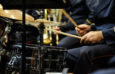 Drummer playing drum kit at live concert