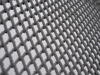 close-up metal mesh covered with a thick layer of snow in the cells