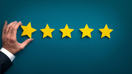 Businessman hand rating company service and giving five stars