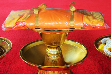 A set of monk’s robes placed on a golden tray