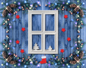 Christmas cottage window decorated with New Year decor in rustic vintage style with light...