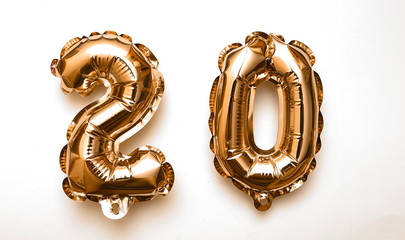 Symbol 20 , golden balloons on white background.