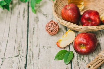 Fototapeta na wymiar Fresh apples in basket on wooden table