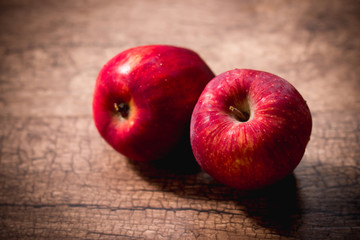 Fresh red apples in wooden background
