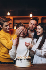 Group Of  Happy Friends Celebrating Birthday With Party Cake At Home
