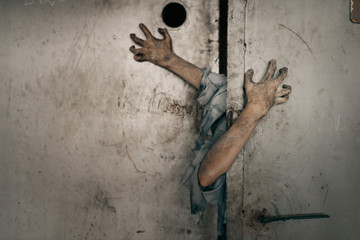 Zombie hands sticking out of the elevator door