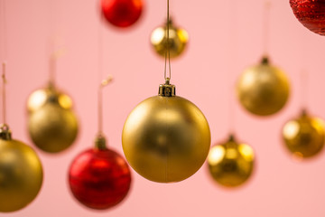 Yellow and red christmas balls on pink background