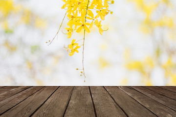 Naklejka na ściany i meble Yellow golden shower (Cassia fistula) in summer with wood textured backgrounds