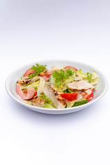 white deep plates with fresh salad ingredients mixed with sauce placed on isolated white background. A place for a menu, banner or advertisement