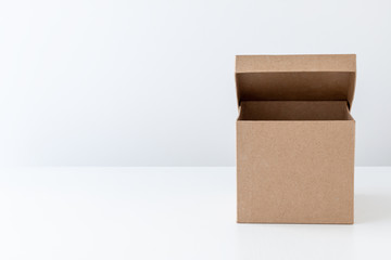 Half-open cardboard box on a white background. Front view.