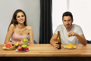 A man leads a wrong lifestyle, he eats chips and beer.