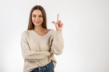 pretty woman showing two fingers and counting isolated over white