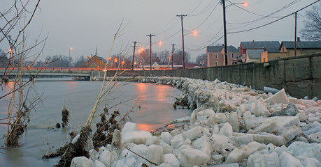 a long exsposer of an Ice floe pushed up onto the river bank and against the river containment wall on the Eel river in logansport Indiana  