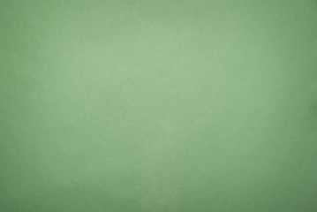Green paper sheet texture background. Top view.