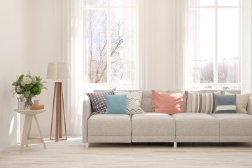 Stylish room in white color with comfortable sofa and winter landscape in window. Scandinavian interior design. 3D illustration