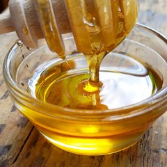 honey in jar on wooden table