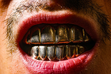 Aggression man with gold teeth. People and aggression concept close up. Emotional angrily screams.