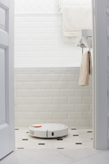 White robot vacuum cleaner in bathroom