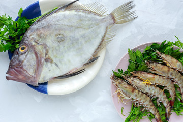 Fresh raw fish from above on white background. Seafood. Flat lay. Octopus. Prawns. St. Peter