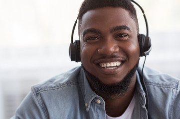 Portrait of joyful african american call center manager in headset