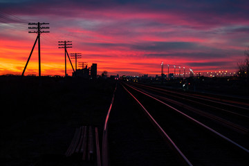 Shining Railway Tracks at a Fiery Sunset