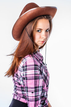 Attractive girl with straight long hair in a cowboy hat