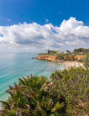 The beach Cap Roig near L'Ampolla under the cloudy sky, Catalonia, Spain