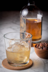 whiskey on the rocks with salted almond