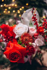 floral arrangement with red and white peony roses, exotic flowers on a Christmas background. flowers close-up. Holiday background for New Year, Christmas, Valentine's Day and Mother's Day.