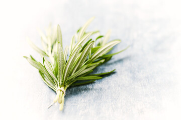 Fresh rosemary on bright wooden background. Close up. 