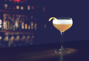 Whiskey Sour Cocktail - Bourbon with Lemon Juice, Sugar Syrup and Egg White in a special glass with copy space