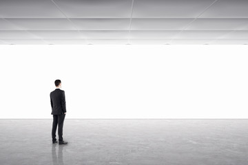 Fototapeta premium Young businessman in gallery interior
