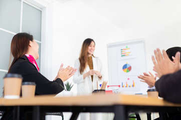 close up hand, audience clapping hands and feeling impressive, asian female officer present about organization business profits with executive board,  they discussion about development performance