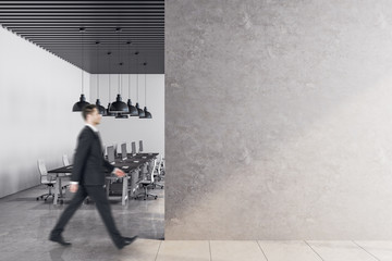 businessman walking in contemporary office