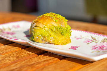 Turkish Midye Baklava ( Mussel Shape Baklava ) with Green Pistachio Powder and Butter Cream.