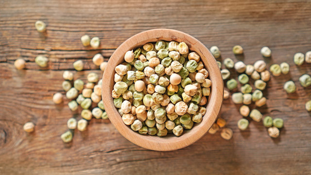 Pea Seeds In A Wooden Plate. Top View.