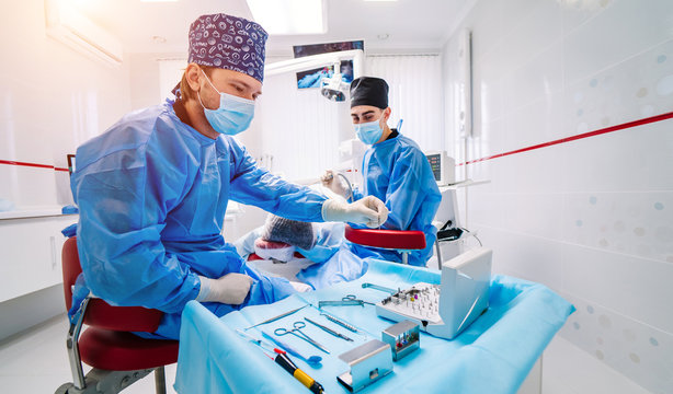 Stomatological instrument in dental clinic. Operation, tooth repairing. Medicine, health, stomatology concept. Doctor in mask. Selective focus.