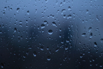 blue rain drops on glass background
