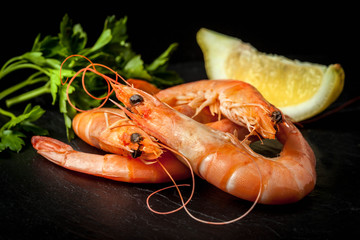 Shrimps for dinner on stone plate.