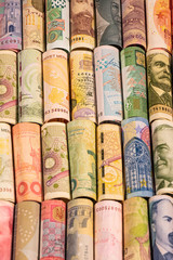 Different banknotes from various countries on rolls